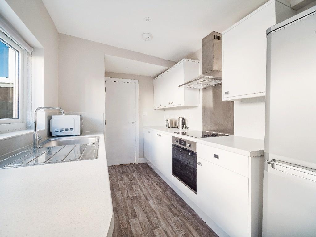 Bright modern kitchen with white units...