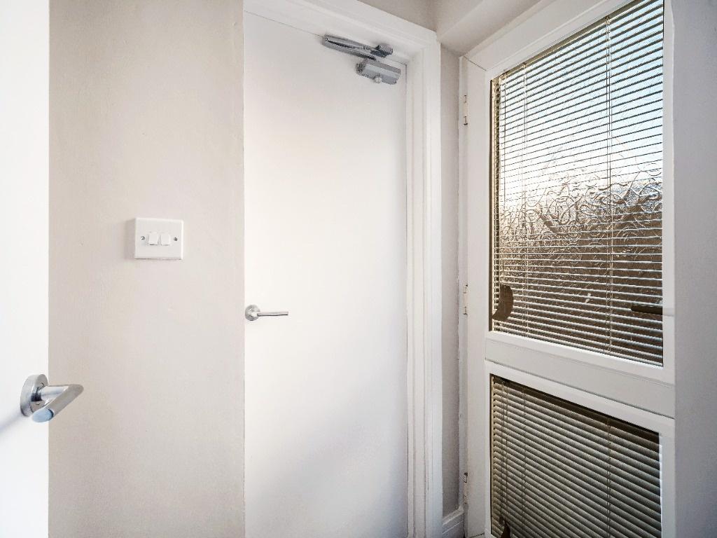 Bright, clean hallway with glazed external door...