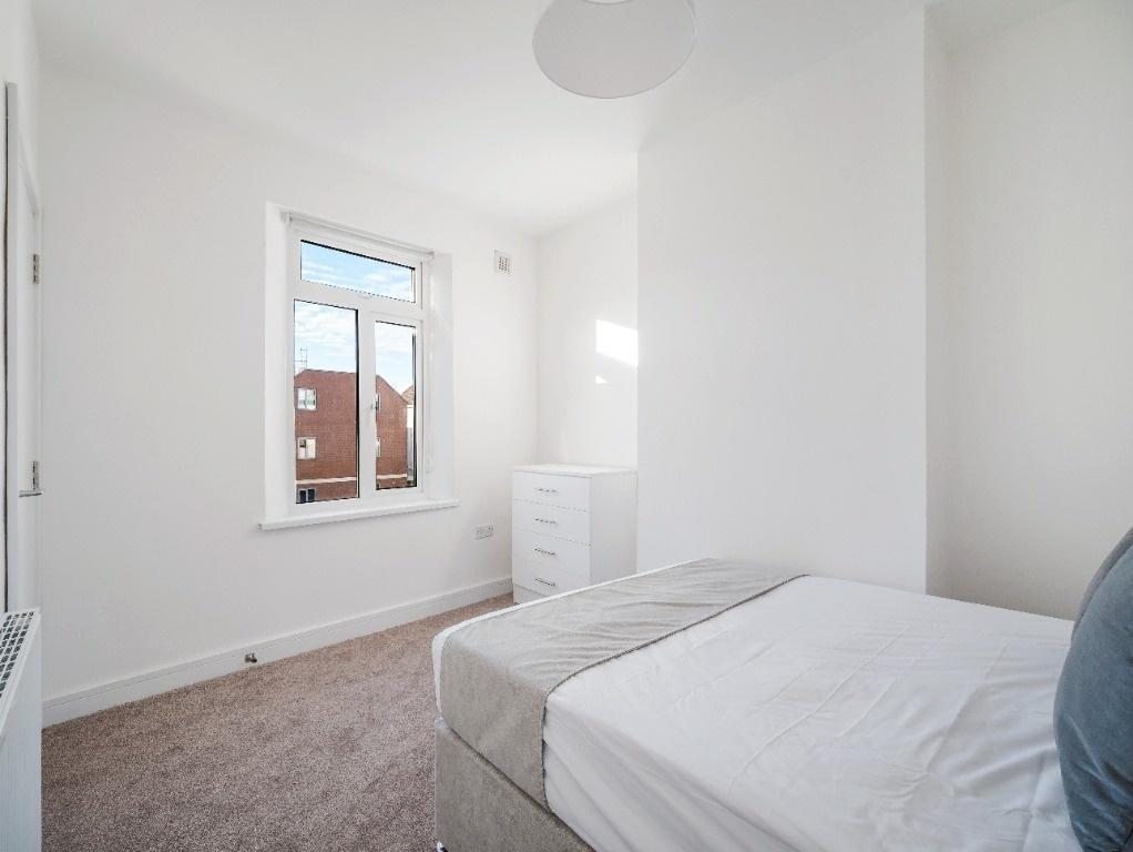 Bright, clean bedroom with neutral decor...