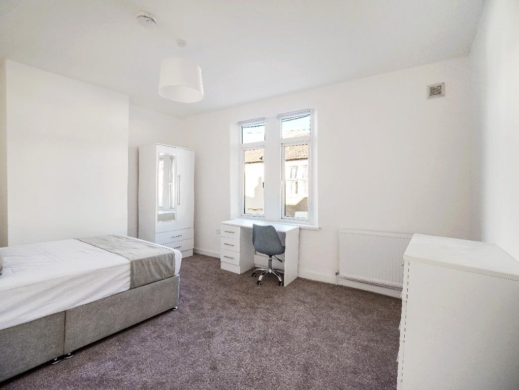 Bright, neutral double bedroom with study area...