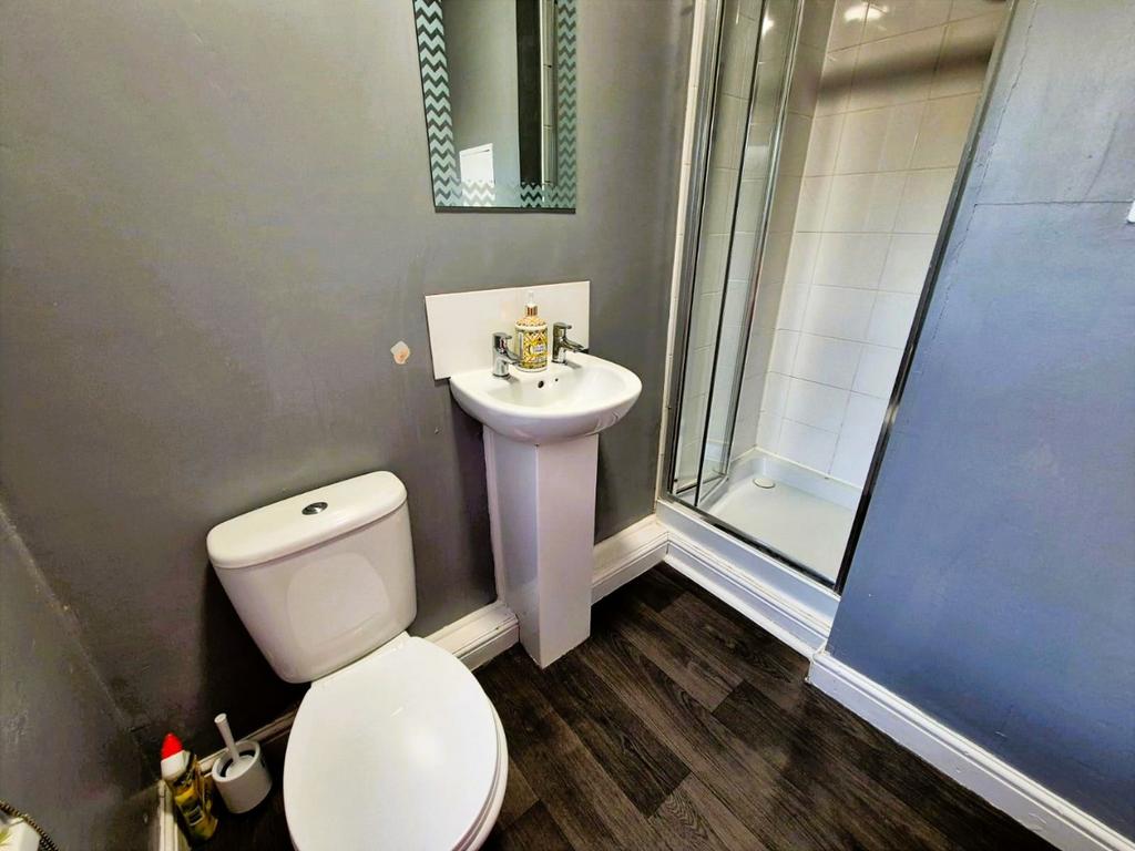 Modern bathroom with shower and pedestal sink...