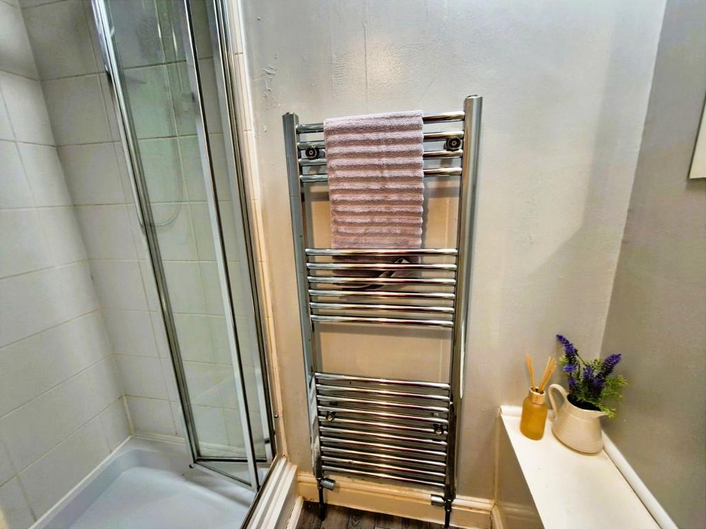 Neat modern bathroom with chrome towel rail...