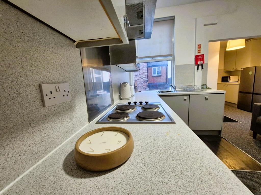 Compact modern kitchen with appliances and coun...
