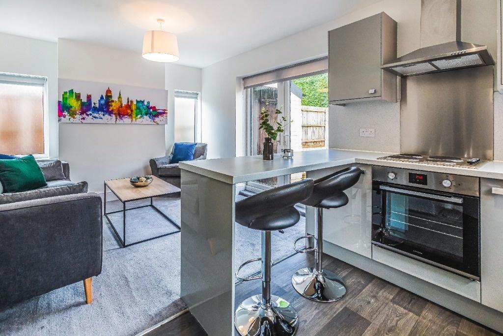 Bright open-plan living area with modern kitche...