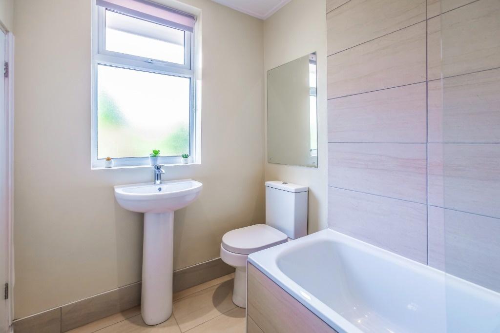 Bright modern bathroom with bath and basin...
