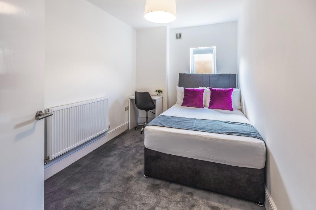Bright, neat bedroom with double bed and desk...