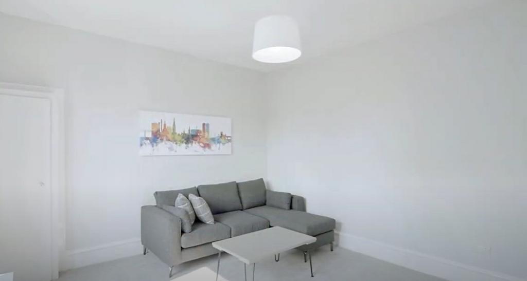 Bright minimalist lounge with sofa and coffee Ta...