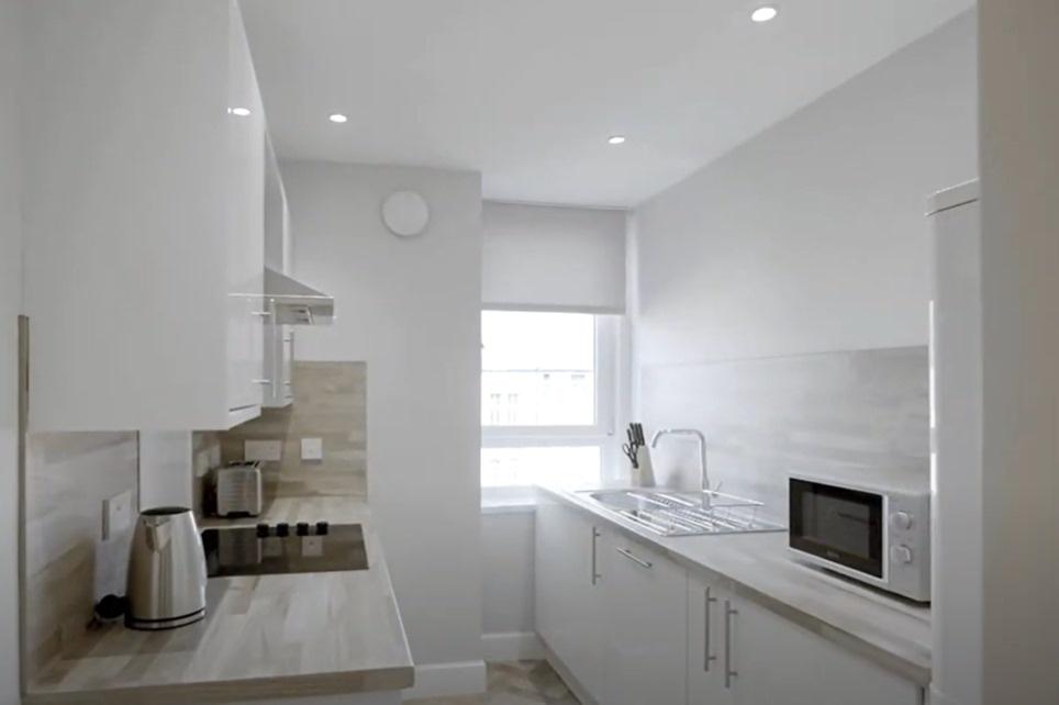 Bright modern galley kitchen with appliances...