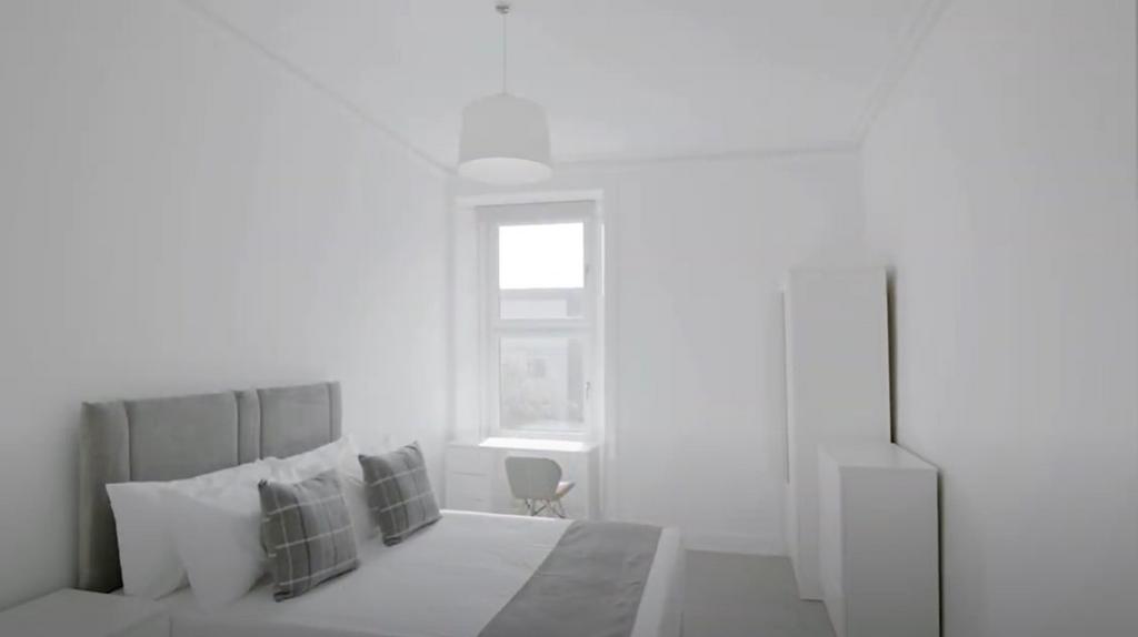 Bright, neatly styled double bedroom with bed a...
