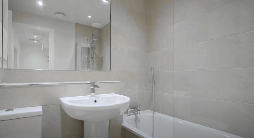 Bright modern bathroom with bath and basin...