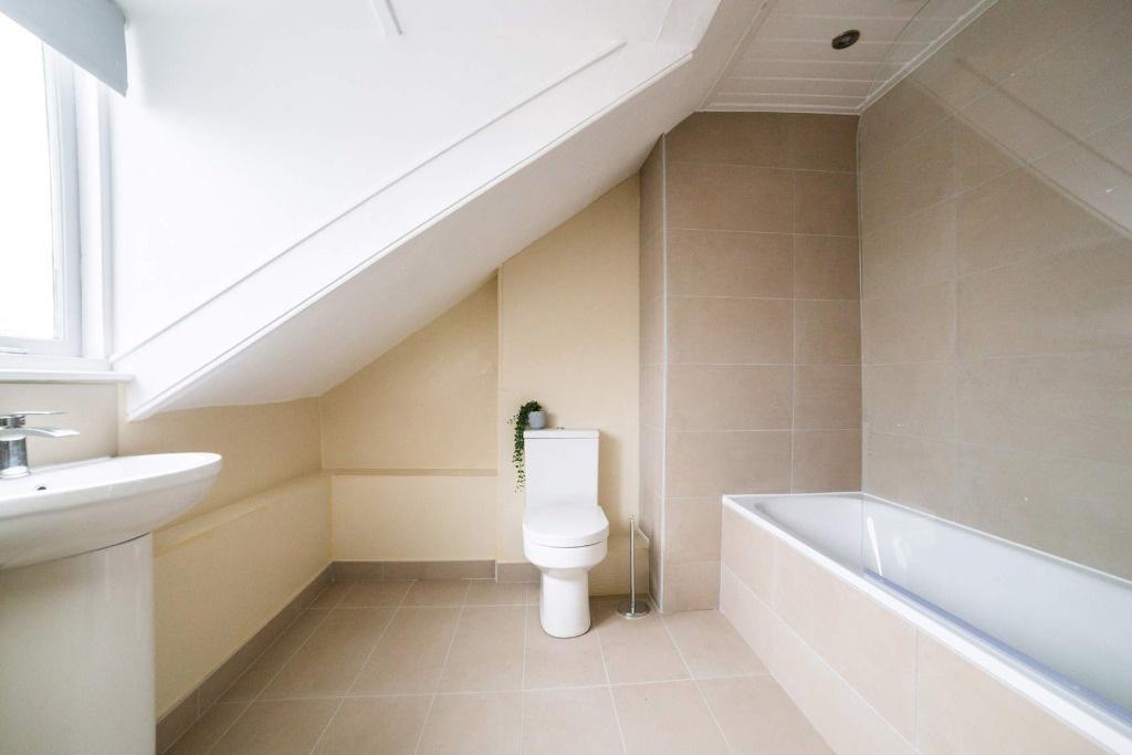 Bright modern bathroom with bath and clean line...