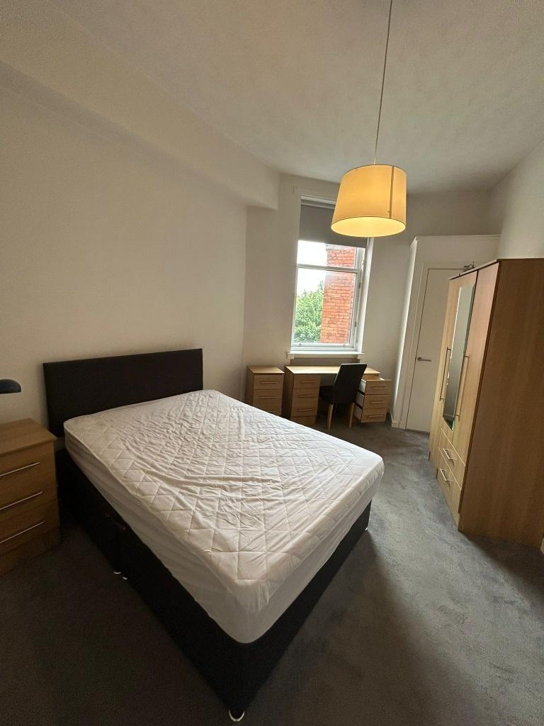 Bright bedroom with double bed and study area...