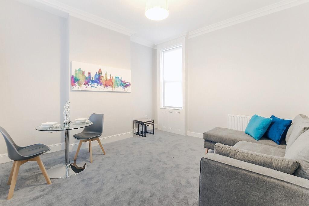 Bright living room with sofa and dining spot...