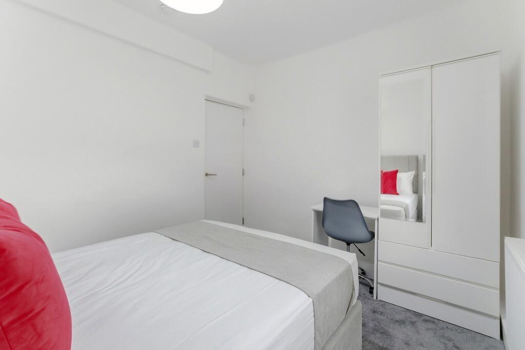 Bright, tidy bedroom with bed and wardrobe...