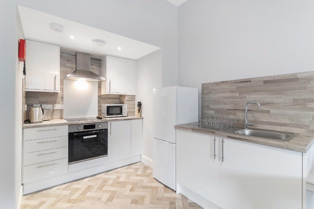 Bright modern kitchenette with integrated oven...