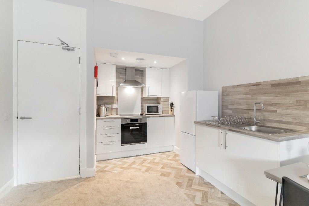 Bright modern kitchenette with integrated oven...