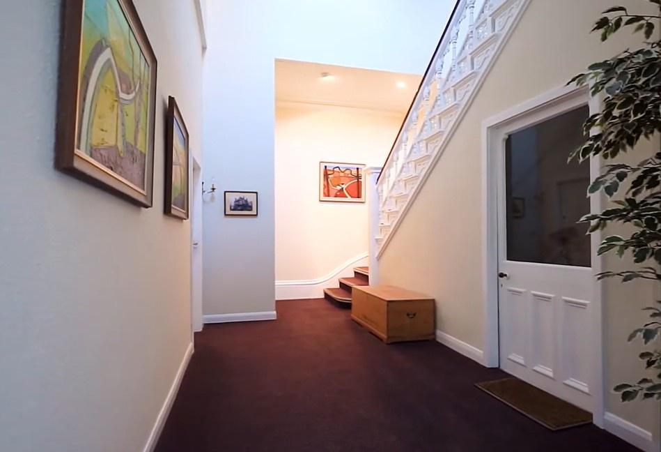 Bright, welcoming entrance hall with stair and ...