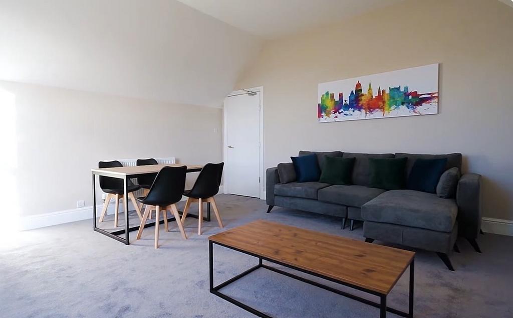 Bright, airy lounge with sofa and dining table...