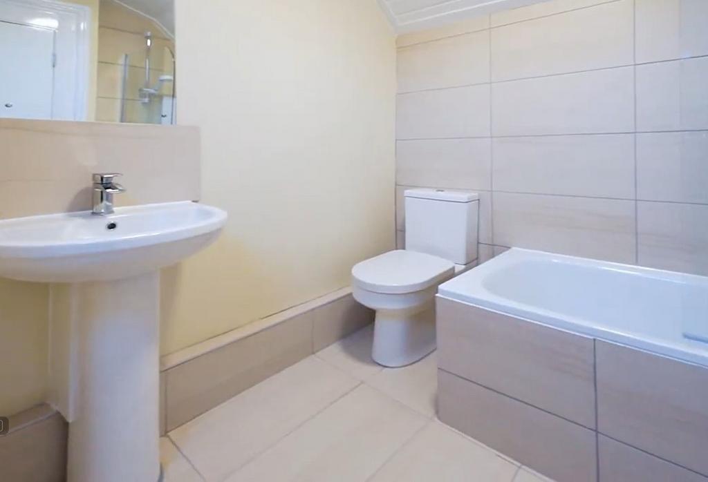 Bright modern bathroom with bath and toilet...