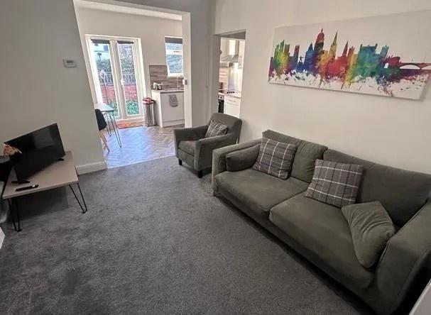 Bright living room with sofa and armchairs...
