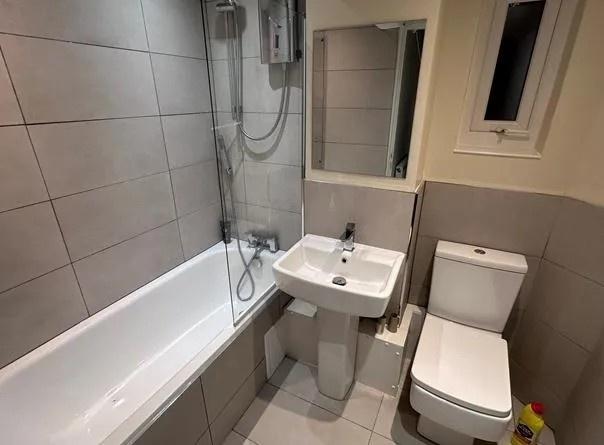 Modern tiled bathroom with bath and sink...
