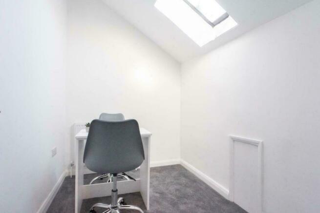 Bright compact room with skylight and desk...