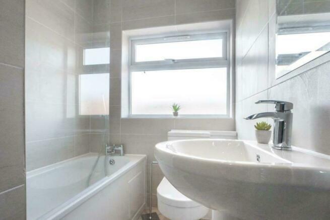 Bright modern bathroom with bath and window...