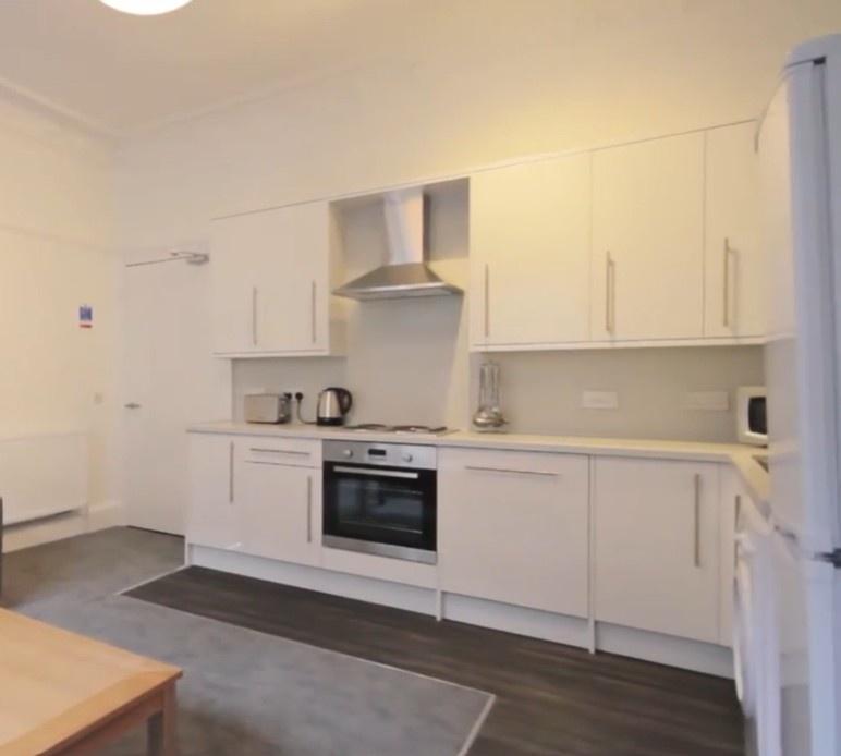 Bright fitted kitchen with appliances and stora...