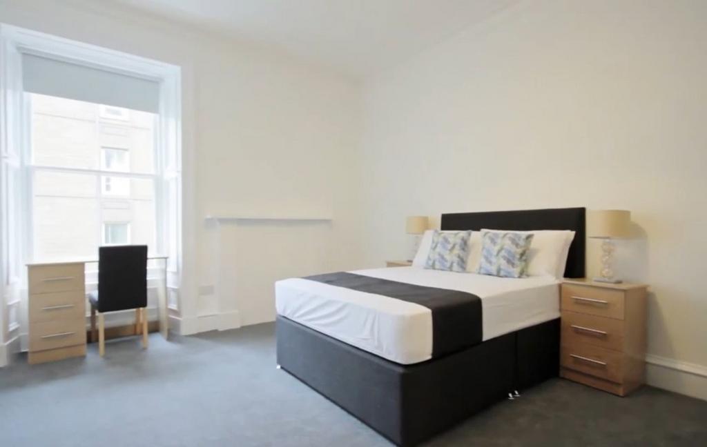 Bright bedroom with double bed and workspace...