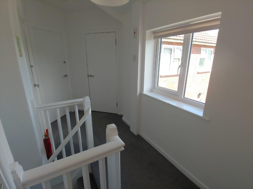 Bright landing with window and neutral decor...
