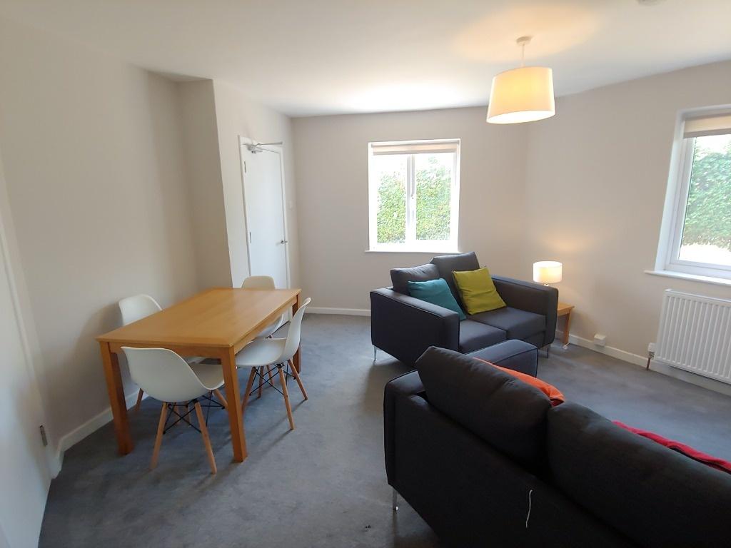 Bright furnished living/dining area with garden...