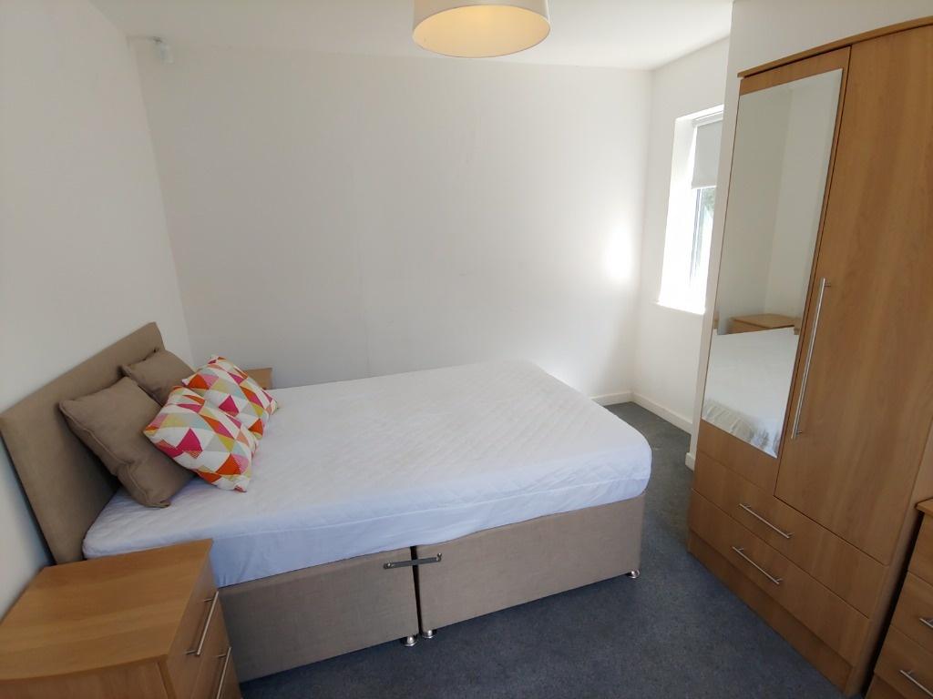 Bright, tidy bedroom with double bed and storag...