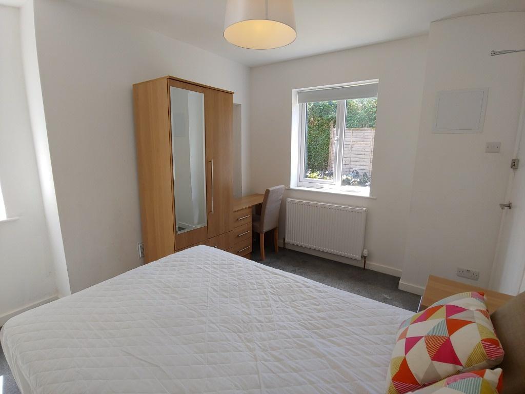 Bright, tidy bedroom with wardrobe and desk...