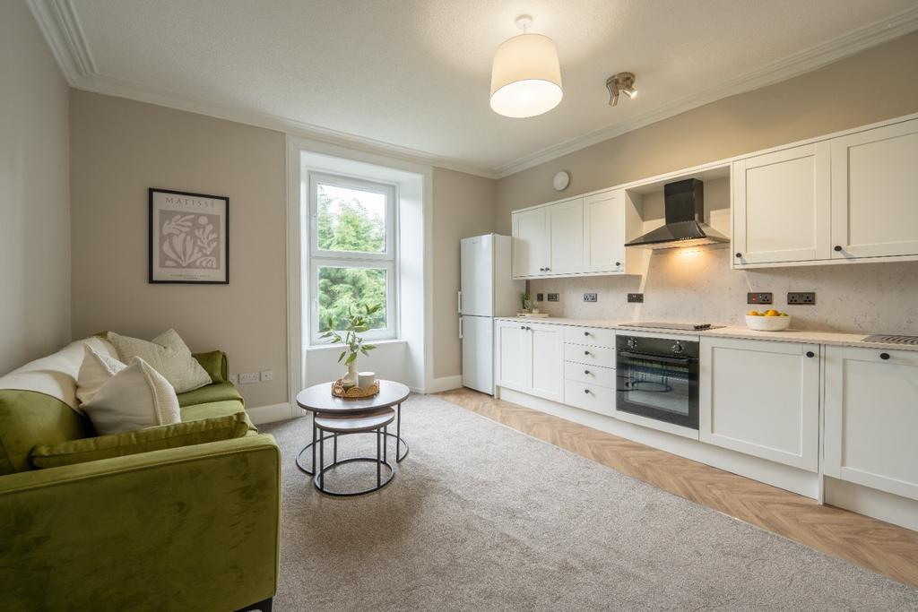 Bright kitchen/lounge with fitted units and sof...