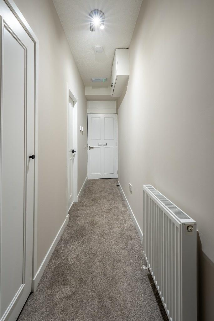 Bright, neutral-tone hallway with clean finishe...