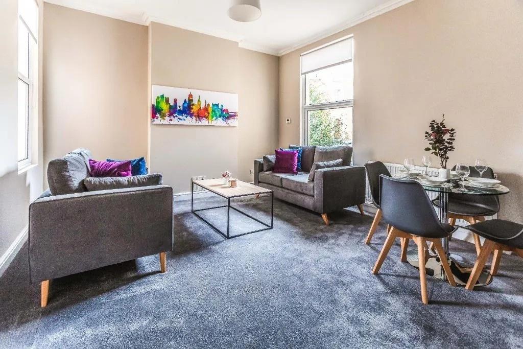 Bright furnished living area with seating and d...