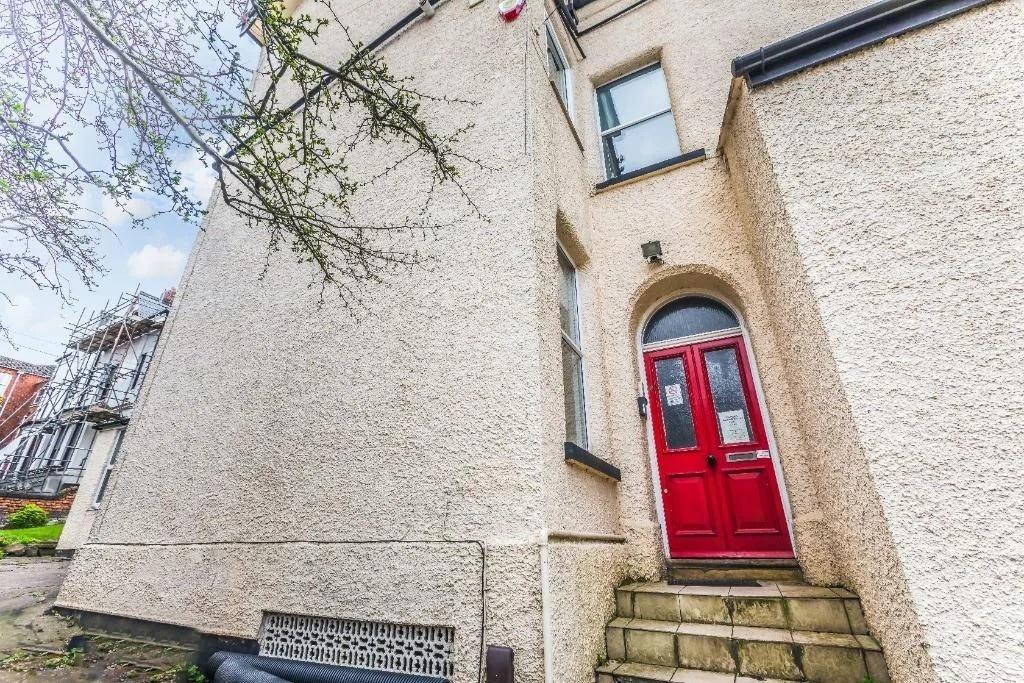 Bright entrance with striking red door...