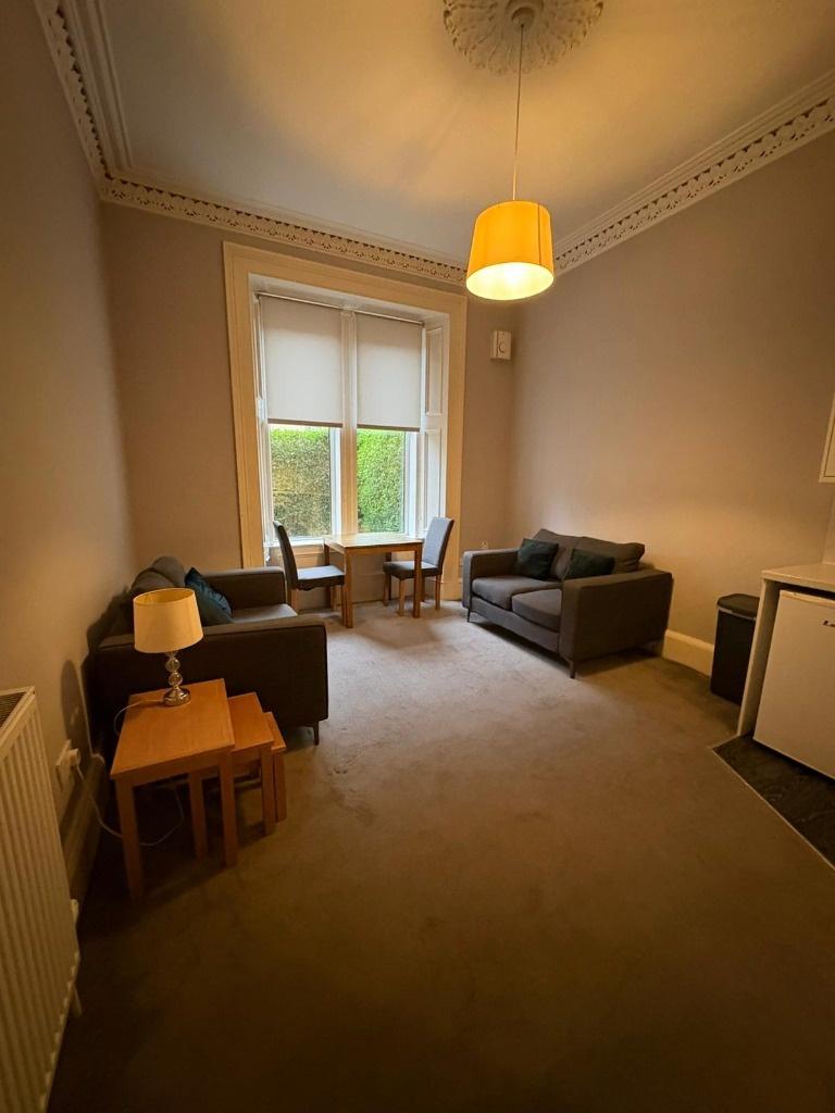 Bright lounge with seating and window view...