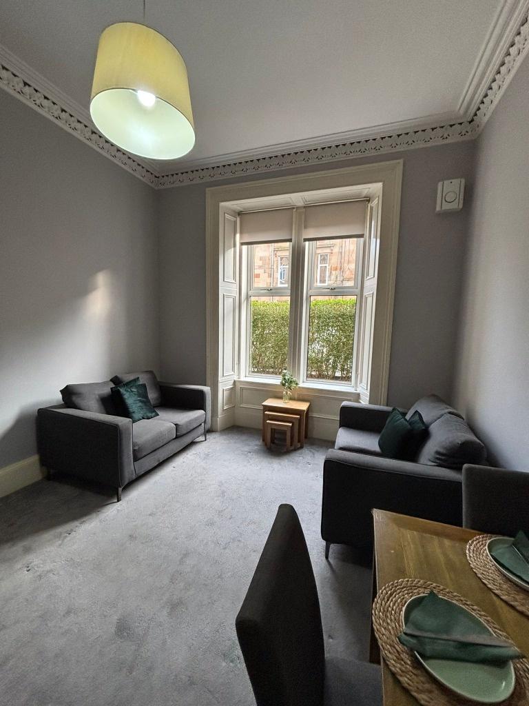 Bright, modern living room with bay window...