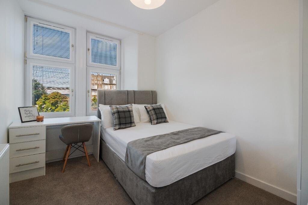 Bright, neat bedroom with desk and double bed...