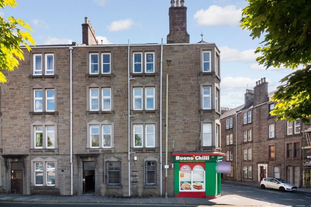 Well-lit traditional tenement with shopfront...