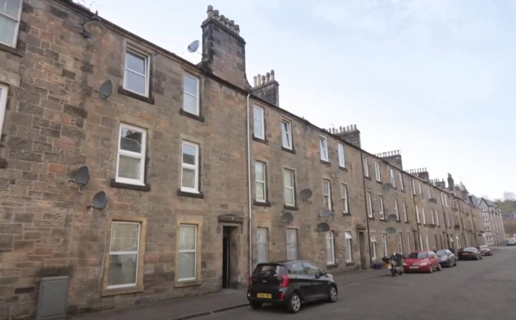 Traditional stone-built street frontage with on...