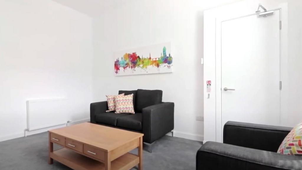 Bright modern living room with sofa seating...