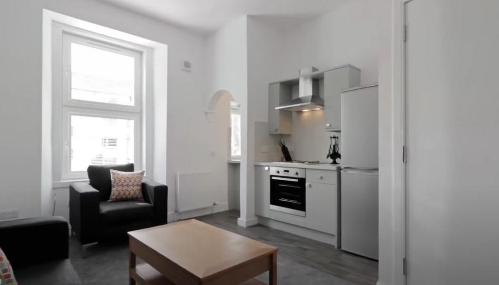 Bright modern lounge with kitchenette and seati...