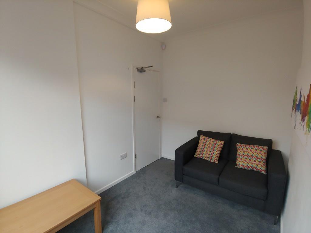 Compact lounge with sofa and neutral decor...