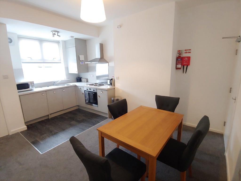 Bright open-plan kitchen-diner with dining tabl...