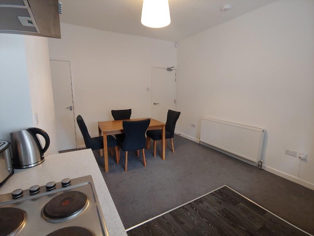 Open-plan kitchen/diner with dining table...