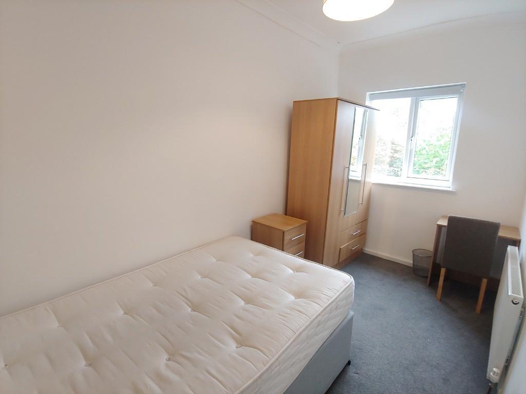 Bright bedroom with wardrobe and desk...