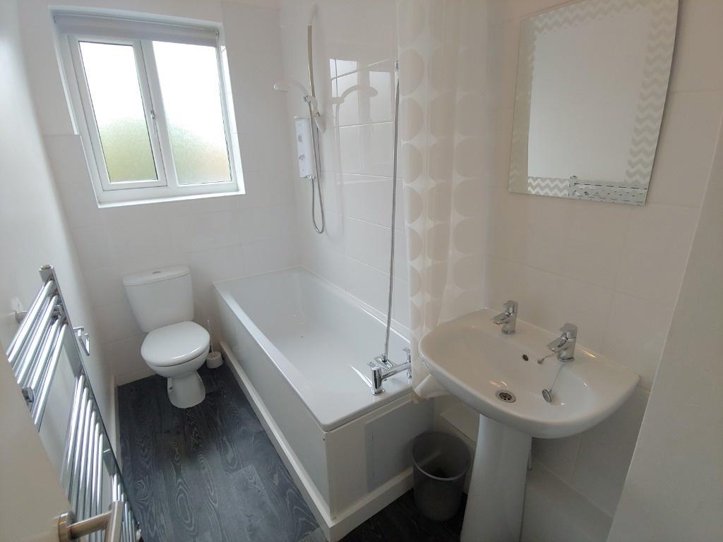 Bright modern bathroom with shower-over-bath...