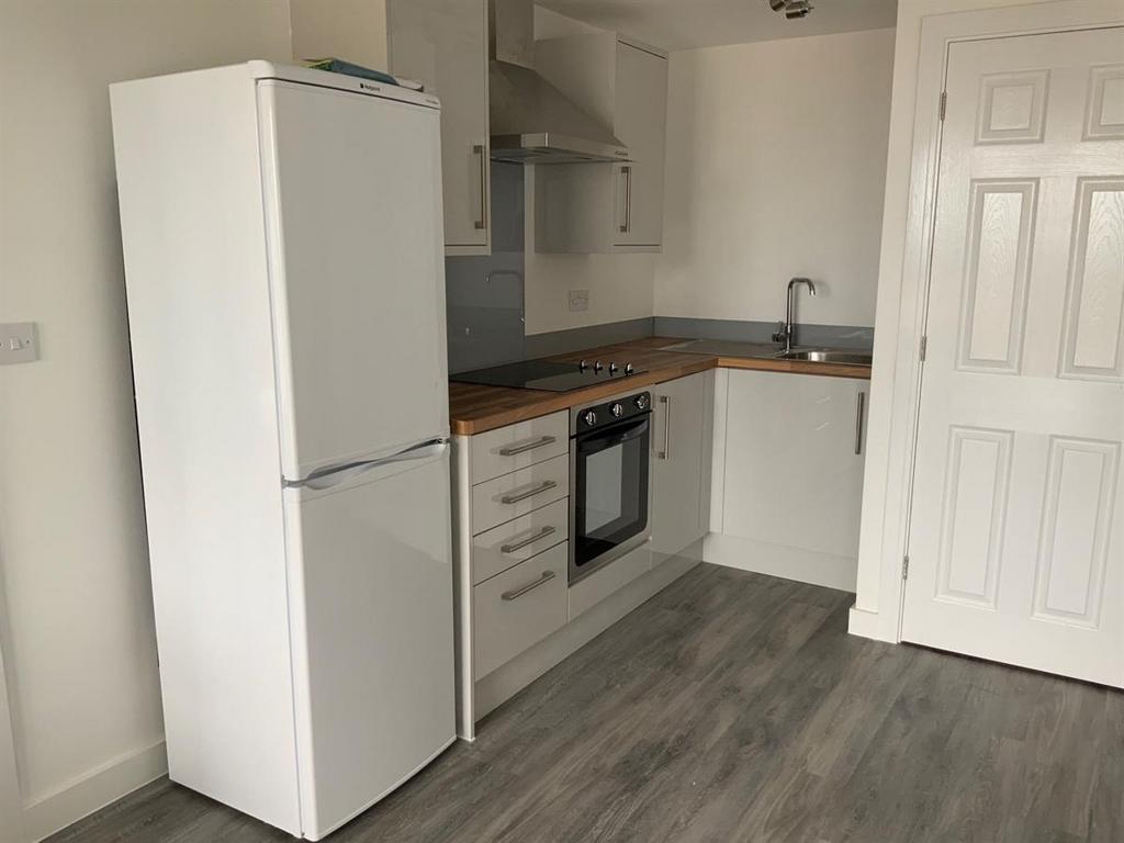 Compact modern kitchen with integrated oven...